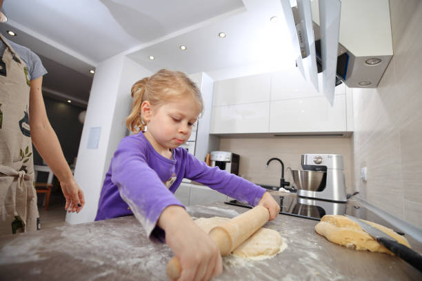 istock Daughter helps mom to bake 903616360