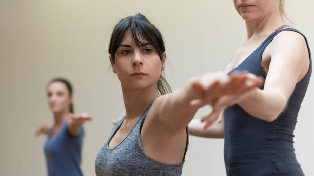 istock Yoga instructor and woman stretching arms 903617358