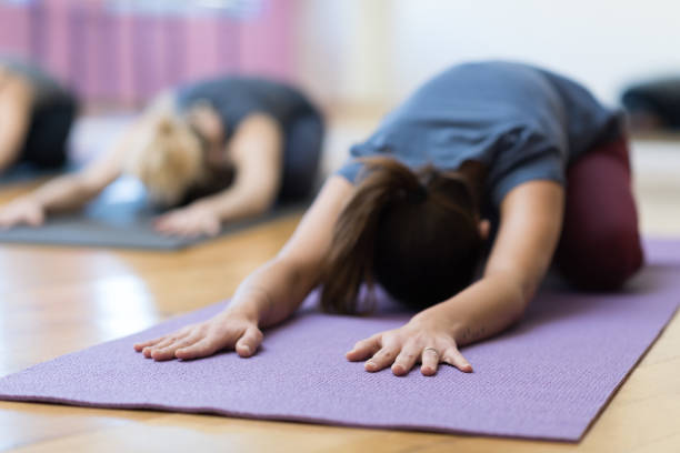 istock Women doing yoga training together 903617394