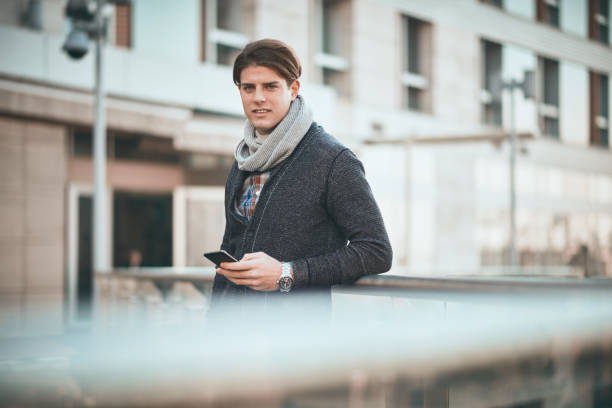 istock Man standing on the balcony and using smart phone. 903617800
