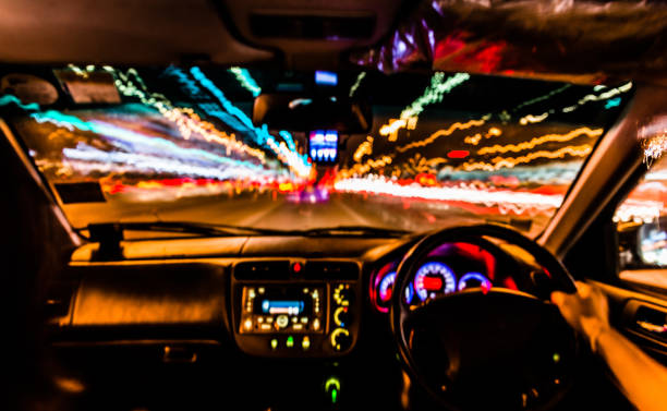 istock Colorful Abstract Defocused motion blurred speed light trails with console inside Car in Night scene 903624364