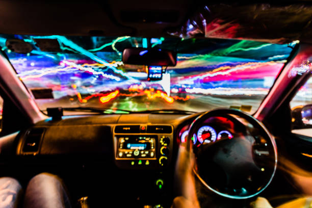 istock Colorful Abstract Defocused motion blurred speed light trails with console inside Car in Night scene 903624368