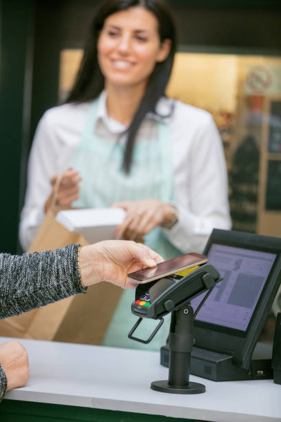 istock Senior woman paying with mobile phone 903624966