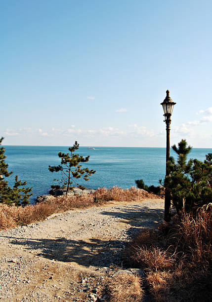 seaview with road and lantern stock photo