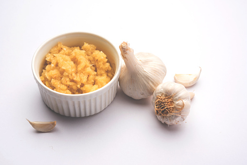 Garlic Paste or Toum or Toumya with raw garlic, isolated over white backgroundGinger/Garlic Powder