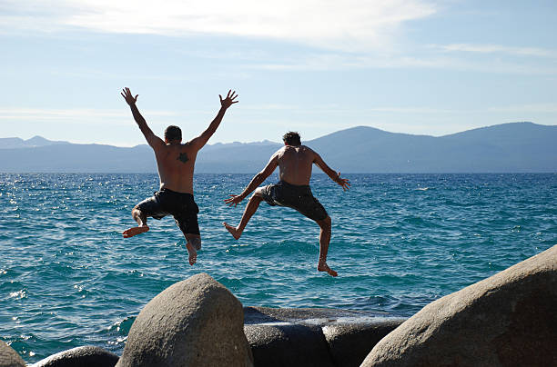 Two men jumping stock photo