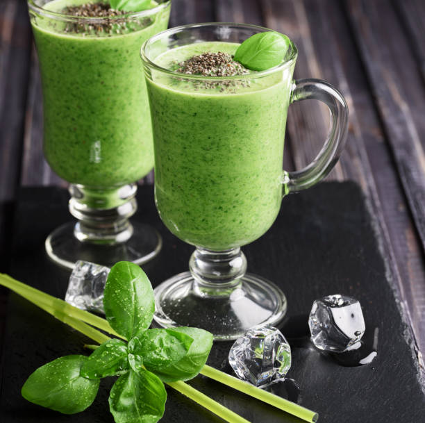 istock Blended green smoothie with ingredients on wooden table 903633326