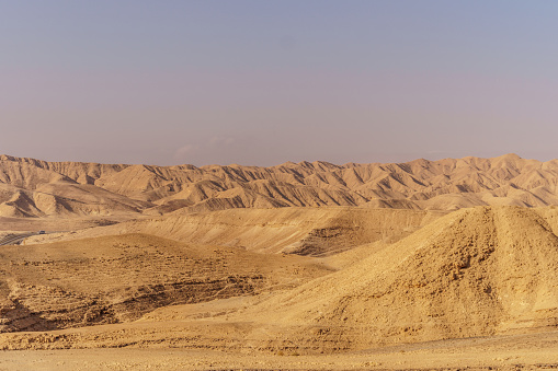 Beautiful nature desert in dry judean picturesque wilderness. Outdoor scenic landscape of mountains, sand and rocks near the dead sea. Travel in middle east