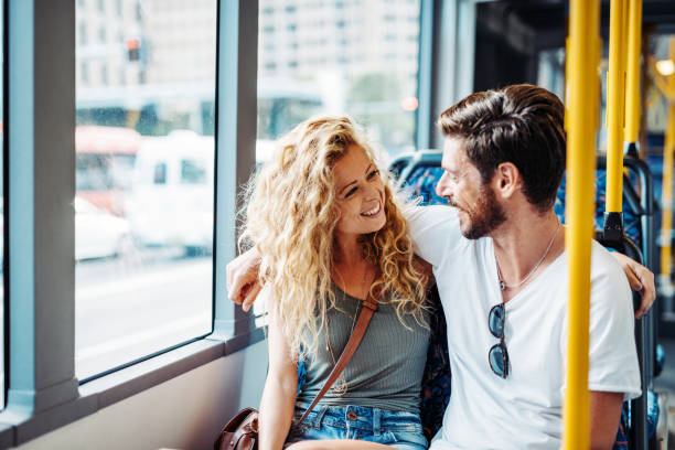 istock Couple sitting in bus seats and commuting back home 903635916