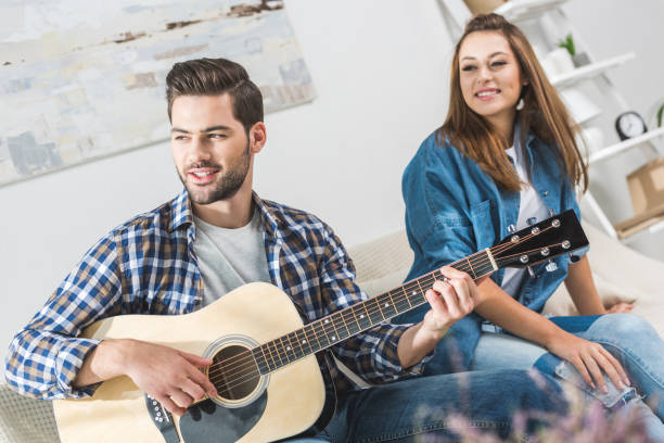 istock Couple on sofa with guitar 903637114