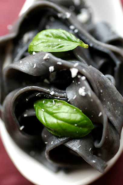 Black noodles with herbs stock photo