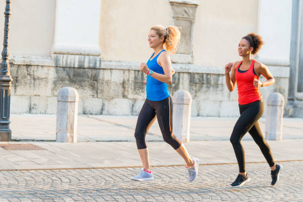 istock Two female athletes running together 903637348