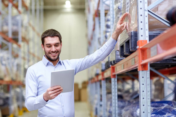 istock happy businessman with tablet pc at warehouse 903637496