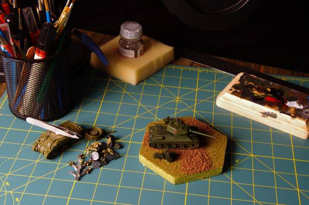 istock Desk top with plastic model hobby equipment including brushes, knives, glue, and others 903641824
