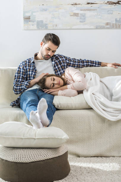 istock Young man watches girlfriend sleep 903642526