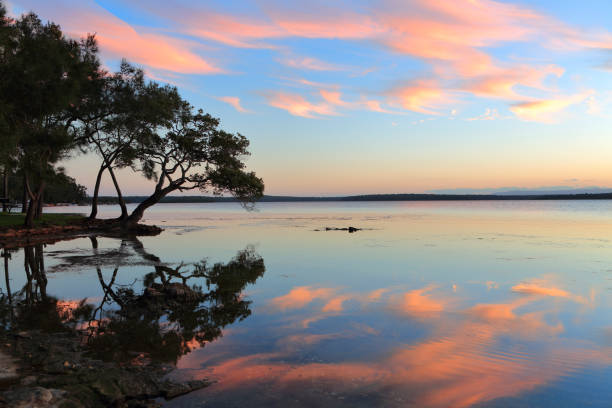 Pretty reflections in the water like a mirror at sunset Sunset and reflections in the serene inlet.  Location St Georges Basin Australia shoalhaven stock pictures, royalty-free photos & images