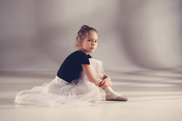 istock The little balerina dancer on gray background 903649582