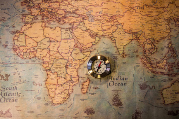 istock Old vintage retro golden compass on ancient map. Selective focus, shallow depth of field. Concept of world travel, sightseeing and tourism. 903650650