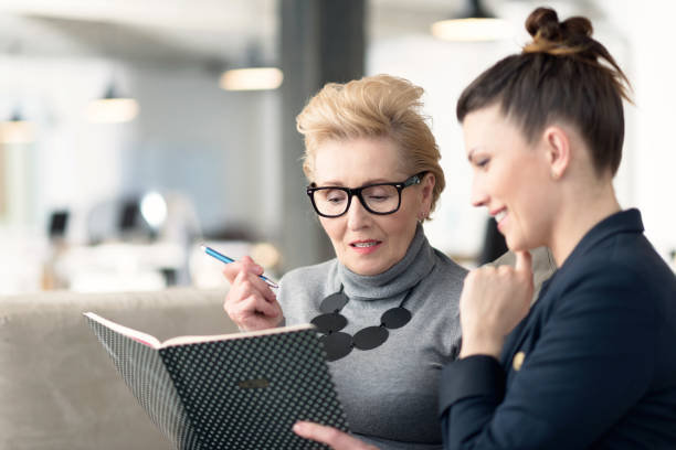Senior adviser talking with young businesswoman