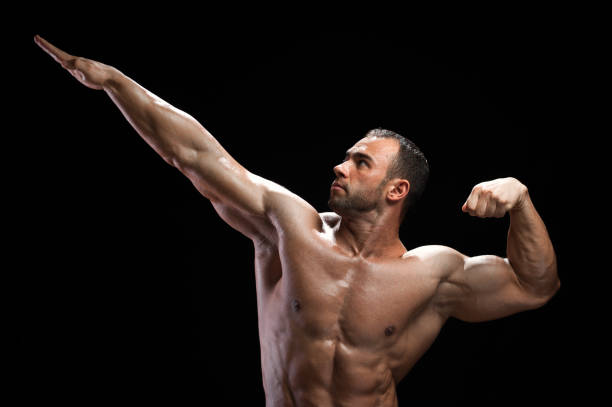 istock Muscular bodybuilder showing perfect trained body 903653166