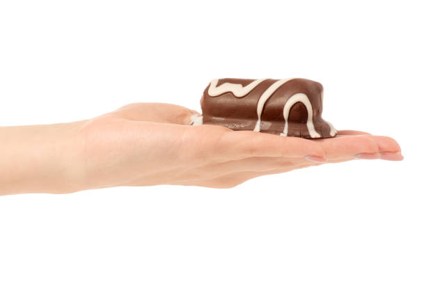 istock Cottage cheese curd  in chocolate glaze in hand 903657566