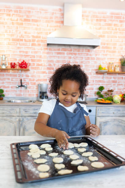 istock Little girl preparing homemade biscuits 903658222