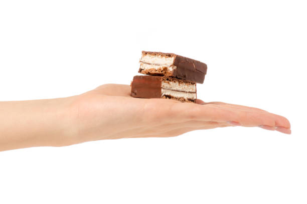 istock Chocolate cake candy biscuit milk in hand 903658322
