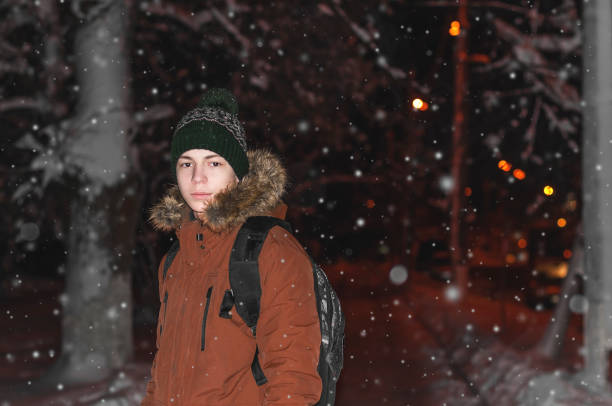 istock young man on a city street during a snowfall 903658680