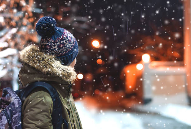istock happy young man on a city street during a snowfall 903659064