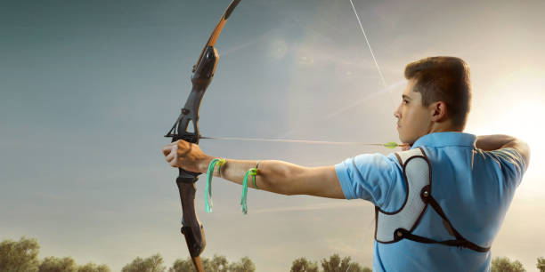 istock Male archer shooting with the longbow at sunset 903659262