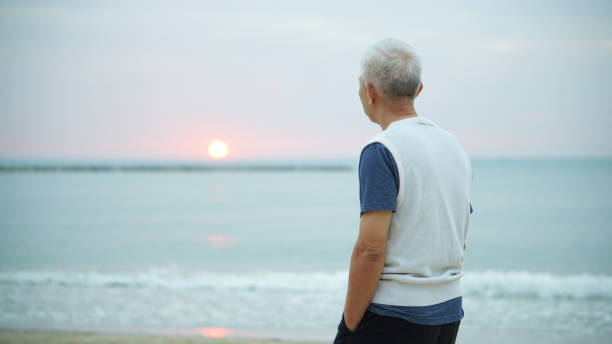istock Asian senior man standing alone at sunrise morning 903659762