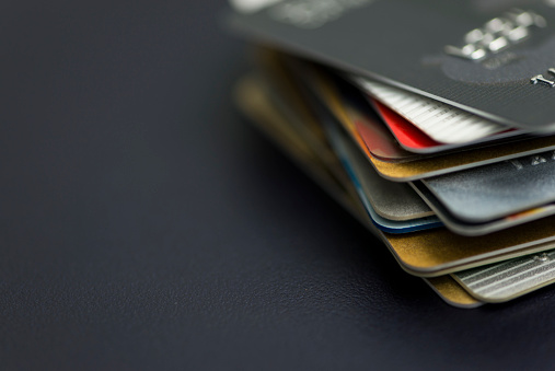 Stack of multicolored credit cards close-up