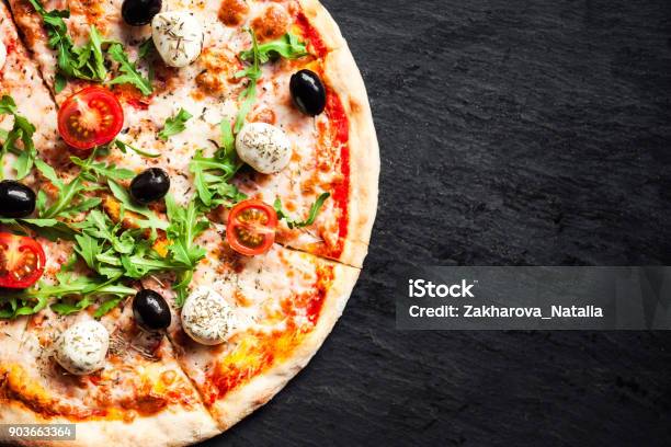 Hot Pizza Slice With Melted Mozzarella Cheese And Tomato On Black Concrete Background Pizza Ready To Eat Copyspacen Stock Photo - Download Image Now