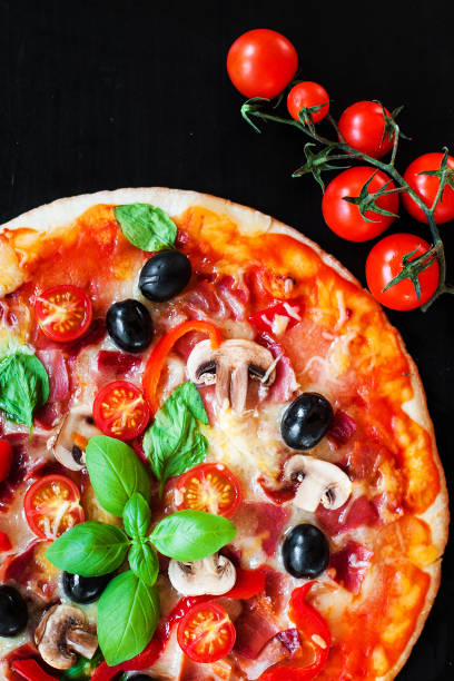 istock Hot pizza with Pepperoni Sausage on a dark background  with copy space. Cheese Pizza 