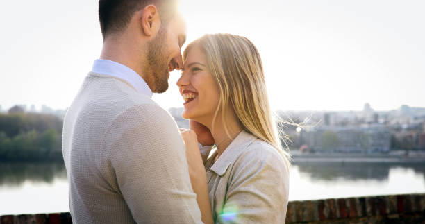 istock Couple kissing dating on bridge 903665776
