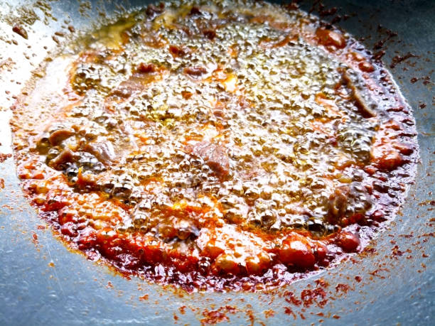 istock Salted beef is being fried in boiling oil, which is in a silver pan. 903666334