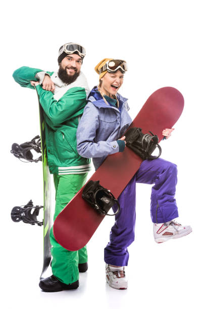 istock couple in snowboarding costumes with snowboards 903666724