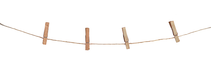 Four wooden clothespins on a rope, isolated on white background