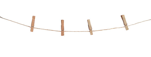 Four wooden clothespins on a rope, isolated on white background Four wooden clothespins on a rope, isolated on white background clothesline photos stock pictures, royalty-free photos & images