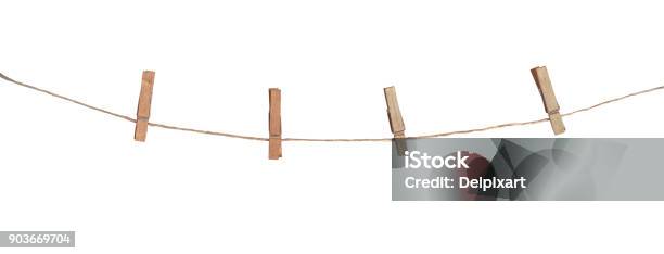 Four Wooden Clothespins On A Rope Isolated On White Background Stock Photo - Download Image Now