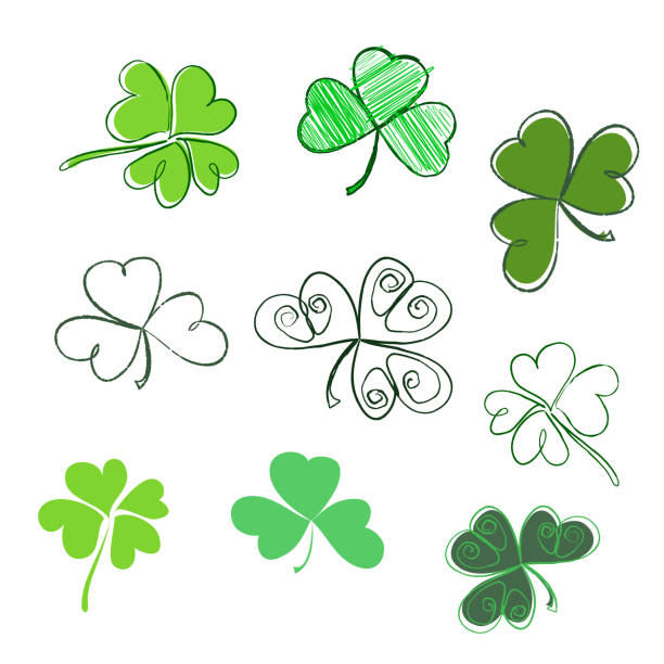 ustaw ręcznie rysowaną koniczynę liściową w kolorach zielonych. trzy i cztery liść, sylwetki, doodle, stylizowane. dzień świętego patryka - celtic style celtic culture circle irish culture stock illustrations