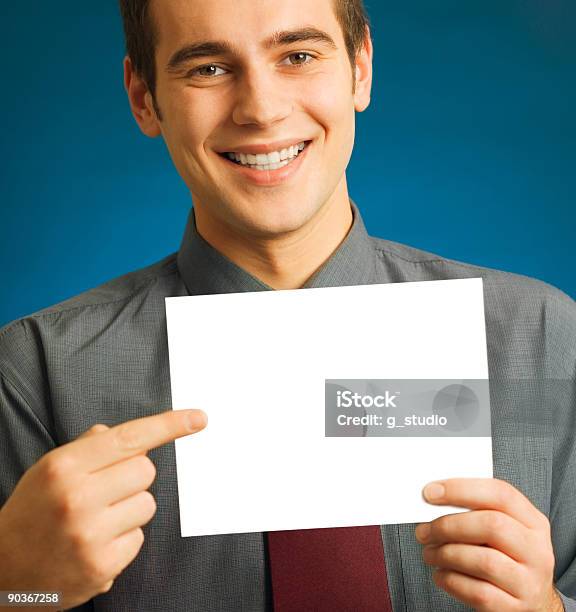 Foto de Feliz Sorridente Jovem Empresário Bem Sucedido Ou Estudante Com Sinal Em Branco e mais fotos de stock de Adulto