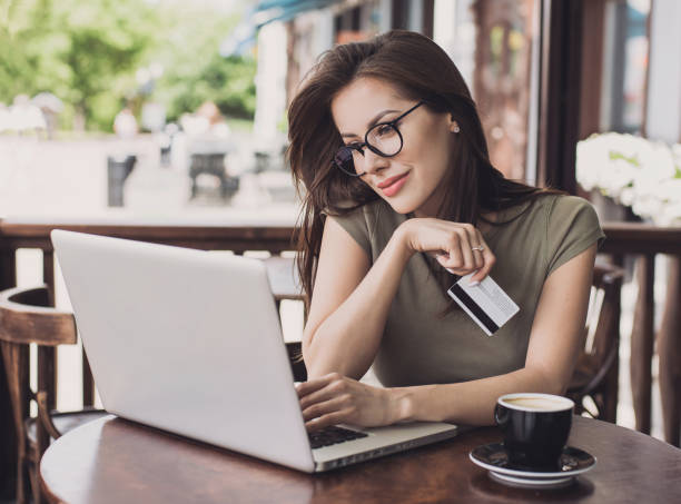 istock Woman is shopping online with laptop computer and credit card 903674708