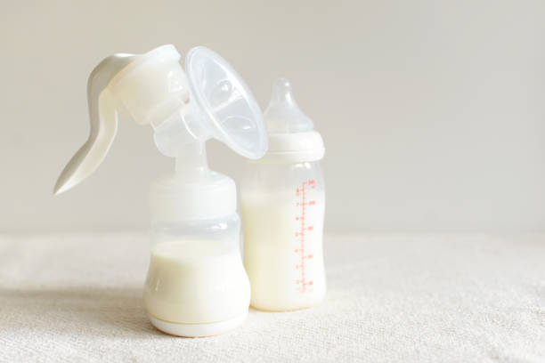 extractor de leche y la botella con leche para el bebé - human nipple fotos fotografías e imágenes de stock