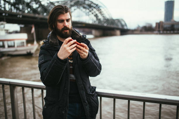 istock Handsome man using phone on a lovely winter day in Germany 903679772