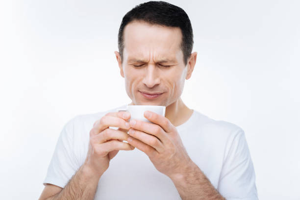 istock Pleasant handsome man blowing at the coffee 903686002
