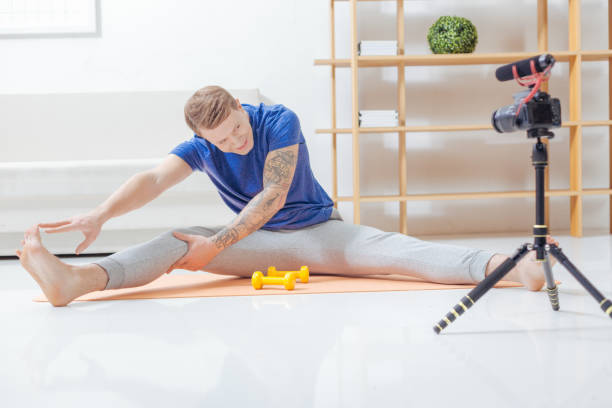 istock Positive trainer touching his toes while exercising on the mat 903686966