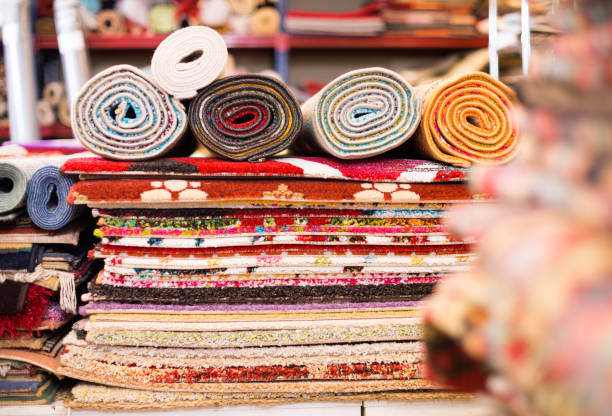 istock Carpets of different colours in stack at carpet store 903687246