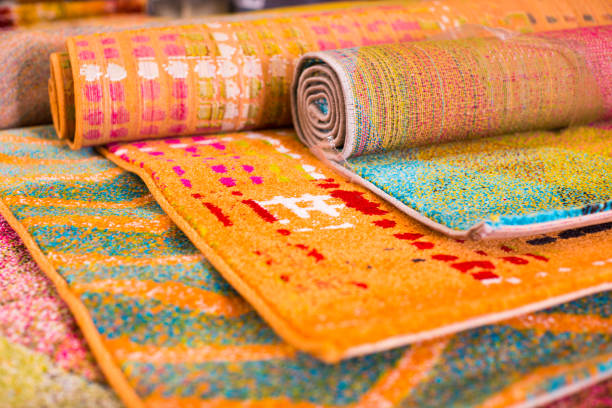 istock Various colorful wool rugs for sale at store 903687272
