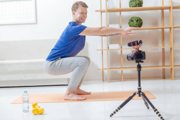 istock Emotional trainer bending his knees while smiling to the camera 903687528